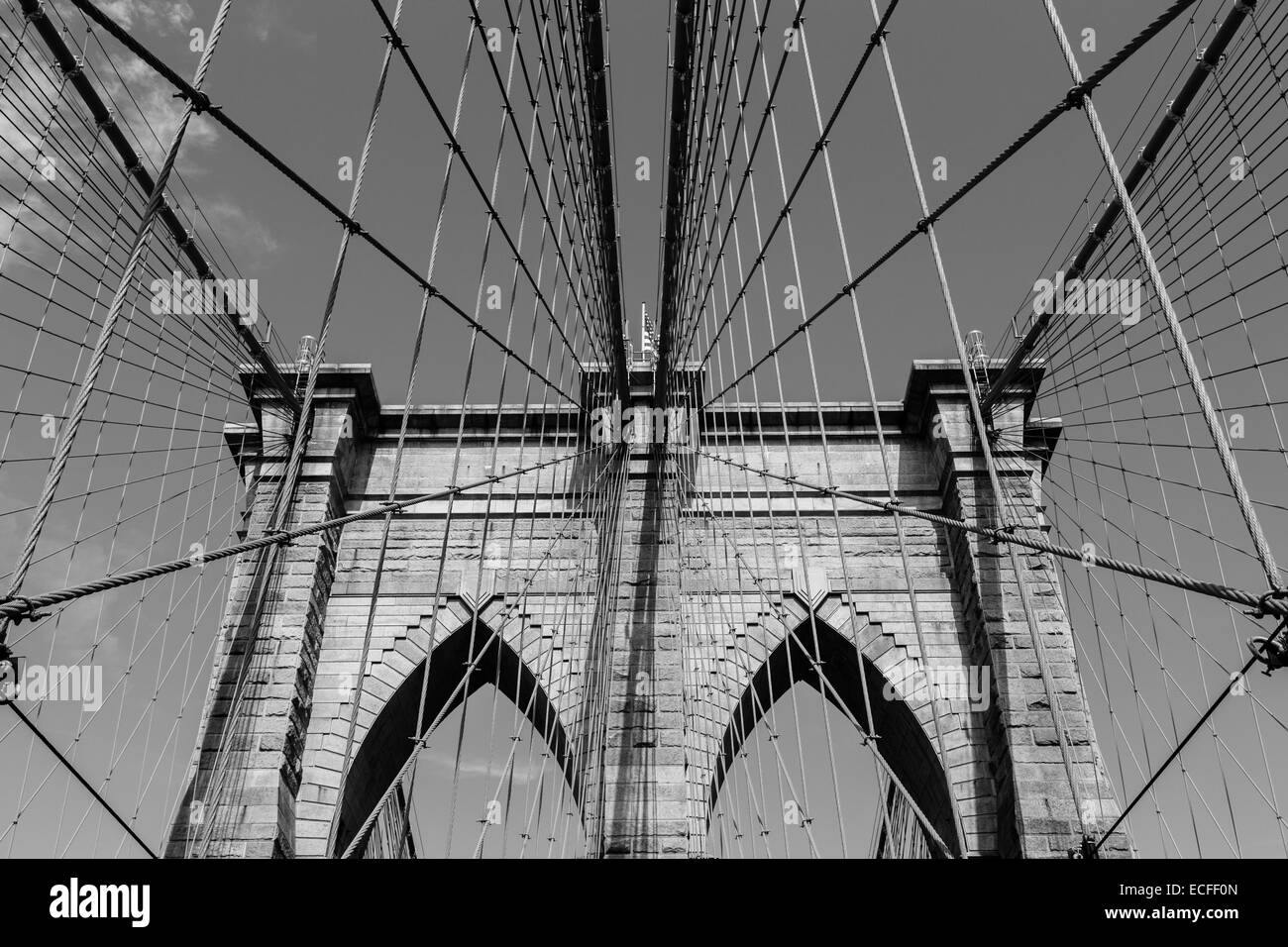 A view of the arches of Brooklyn Bridge in NYC in black and white Stock Photo