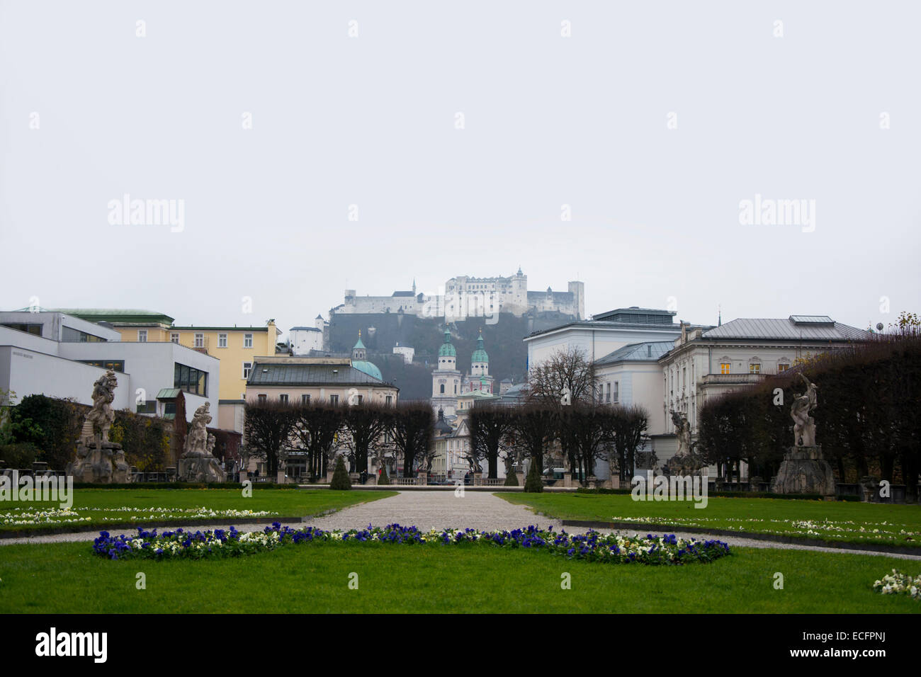 Mirabell Garden in Salzburg on a fogy and cloudy day in December 2014 with a view towards Hohensalzburg castle Stock Photo