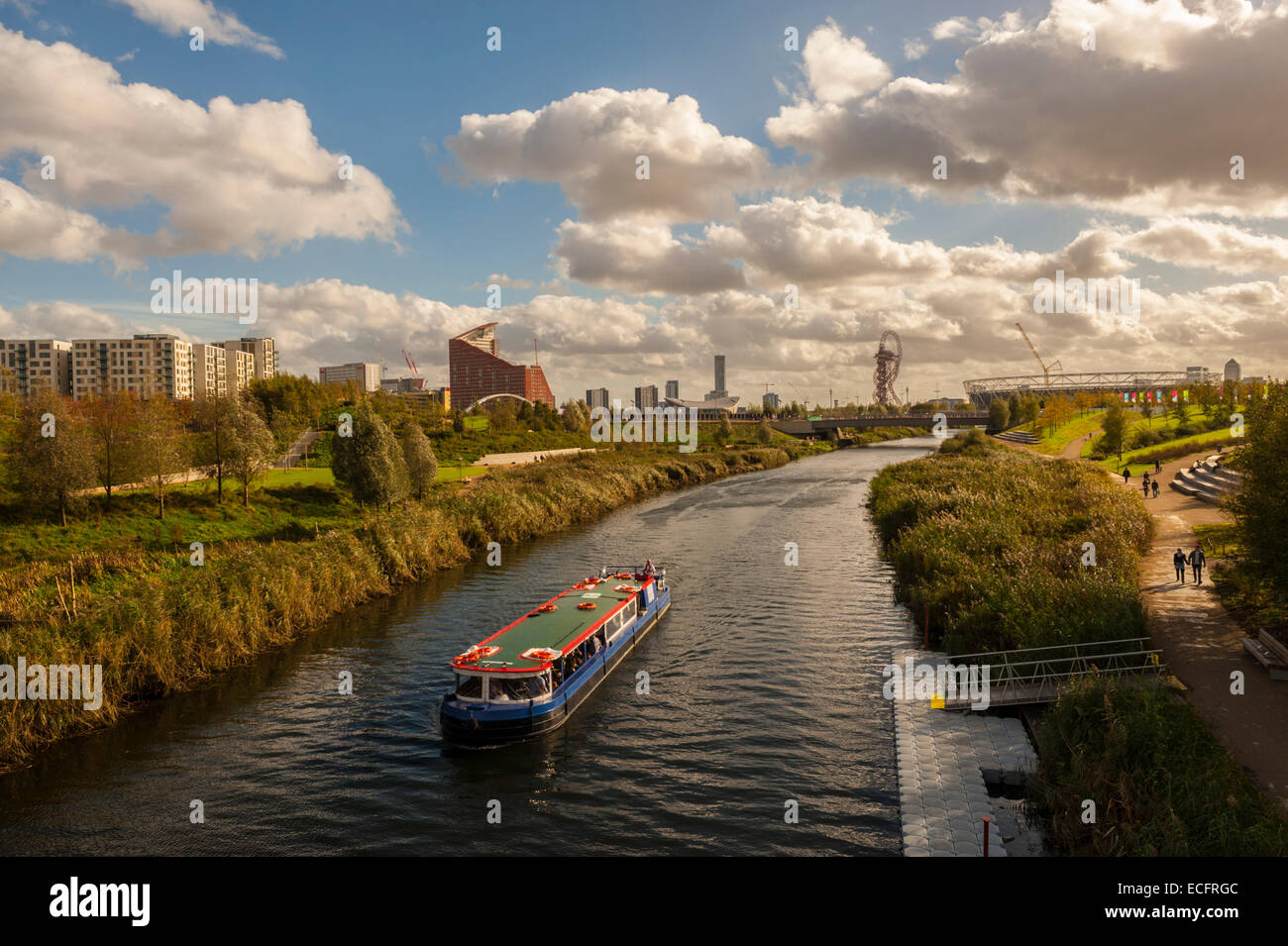 Boat on the river Lea with Stratford City and the Olympic Stadium in background. Stock Photo