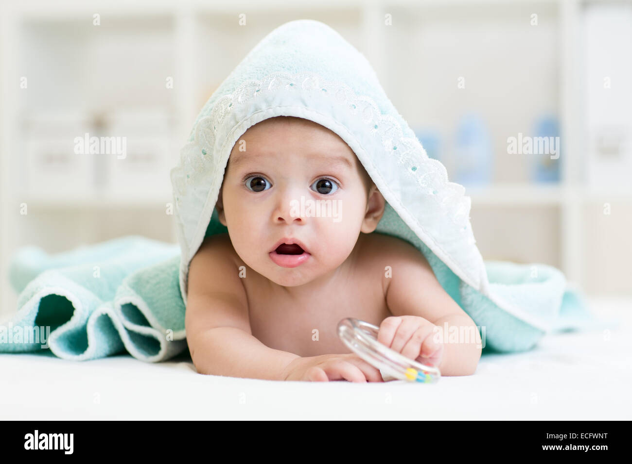 Adorable happy baby in towel Stock Photo