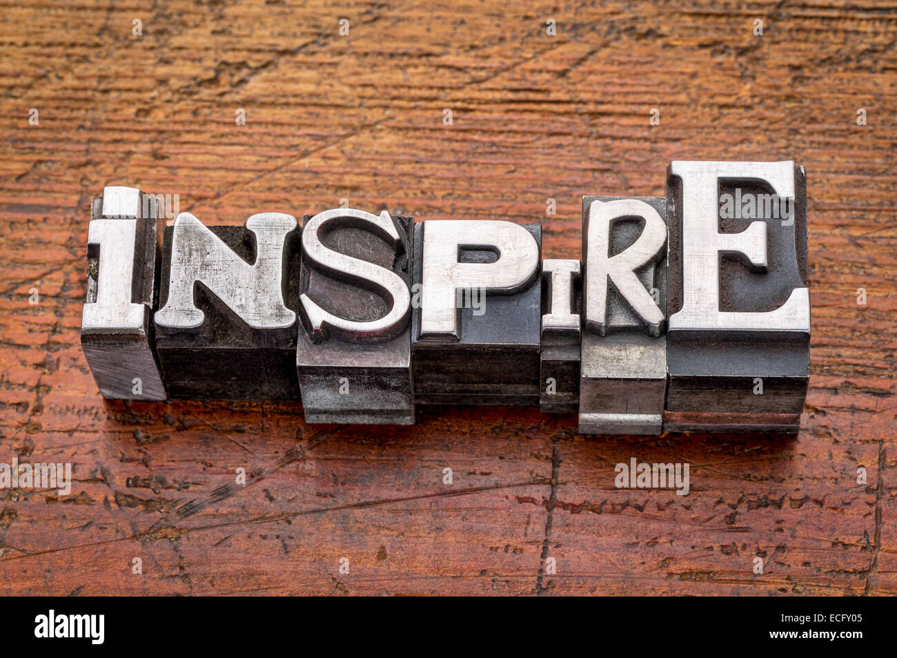 inspire word in mixed vintage metal type printing blocks over grunge wood Stock Photo