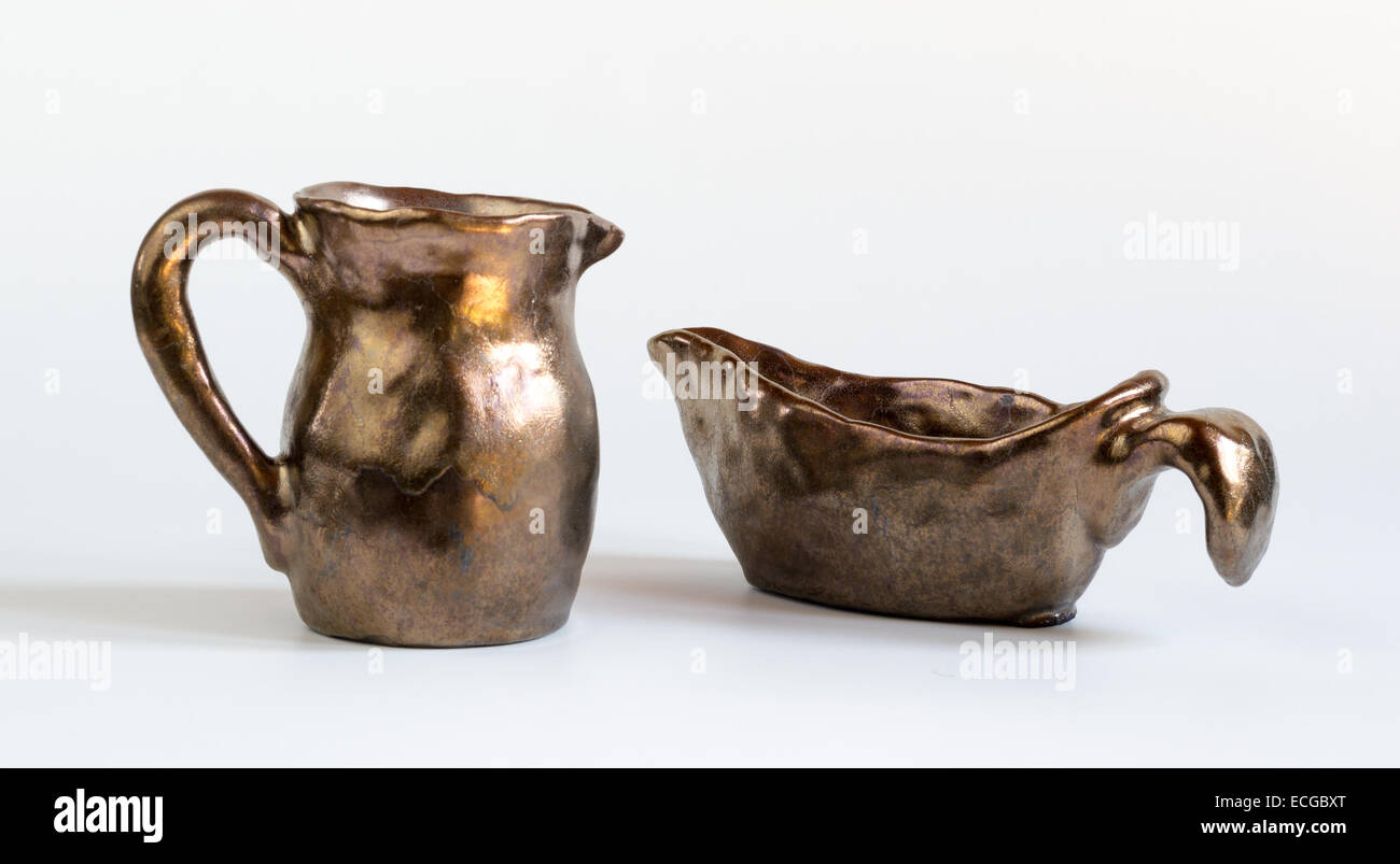 Set of Gold Handmade Clay Vessels on White Background Stock Photo