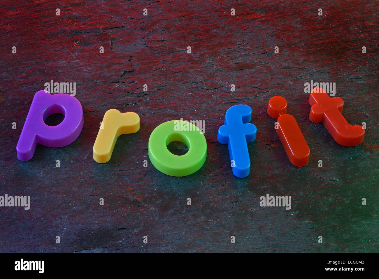 The word 'Profit' spelled out in colorful fridge magnets on a slate background. Concept image denoting business success. Stock Photo