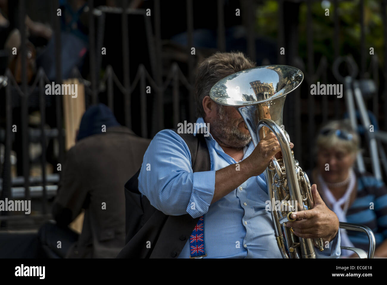Street musician playing a brass horn on Cornmarket, Oxford, UK Stock