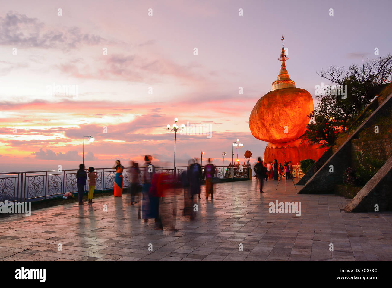 People praying and worship at Kyaikhtiyo pagoda on sunset, one of the most sacred sites in Kyaikhtiyo of Mon state in Myanmar. Stock Photo