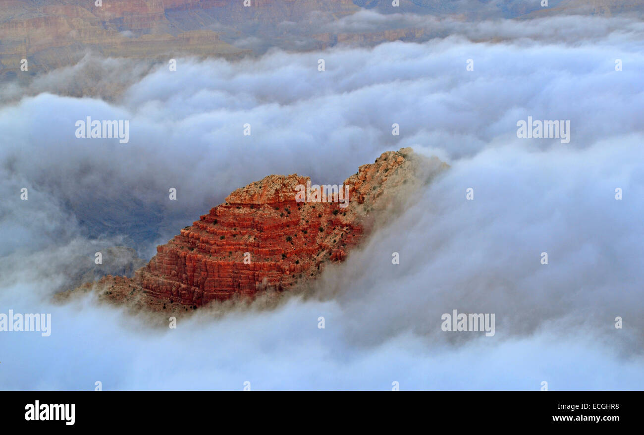 Total cloud inversion looking Desert View from the South Rim December 12, 2014 in Grand Canyon National Park, Arizona. The rare phenomenon is caused when the ground loses heat rapidly at dawn to create a layer of cool, damp air inside the canyon, trapping it beneath the unusually warmer sky above the canyon walls and filling the space with a sea of fog. Park officials said the phenomenon is a once-in-a-decade occurrence. Stock Photo
