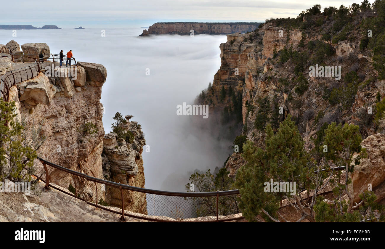 Total cloud inversion as seen from Mather Point on the South Rim December 14, 2014 in Grand Canyon National Park, Arizona. The rare phenomenon is caused when the ground loses heat rapidly at dawn to create a layer of cool, damp air inside the canyon, trapping it beneath the unusually warmer sky above the canyon walls and filling the space with a sea of fog. Park officials said the phenomenon is a once-in-a-decade occurrence. Stock Photo