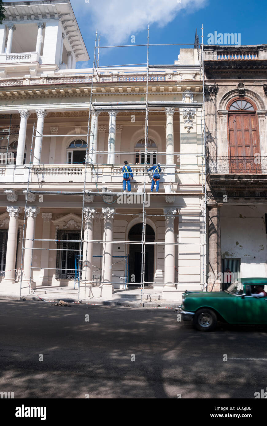 Workmen in the midst of restoring one of the many historic Spanish Colonial buildings that are in need of repair in Havana Cuba Stock Photo