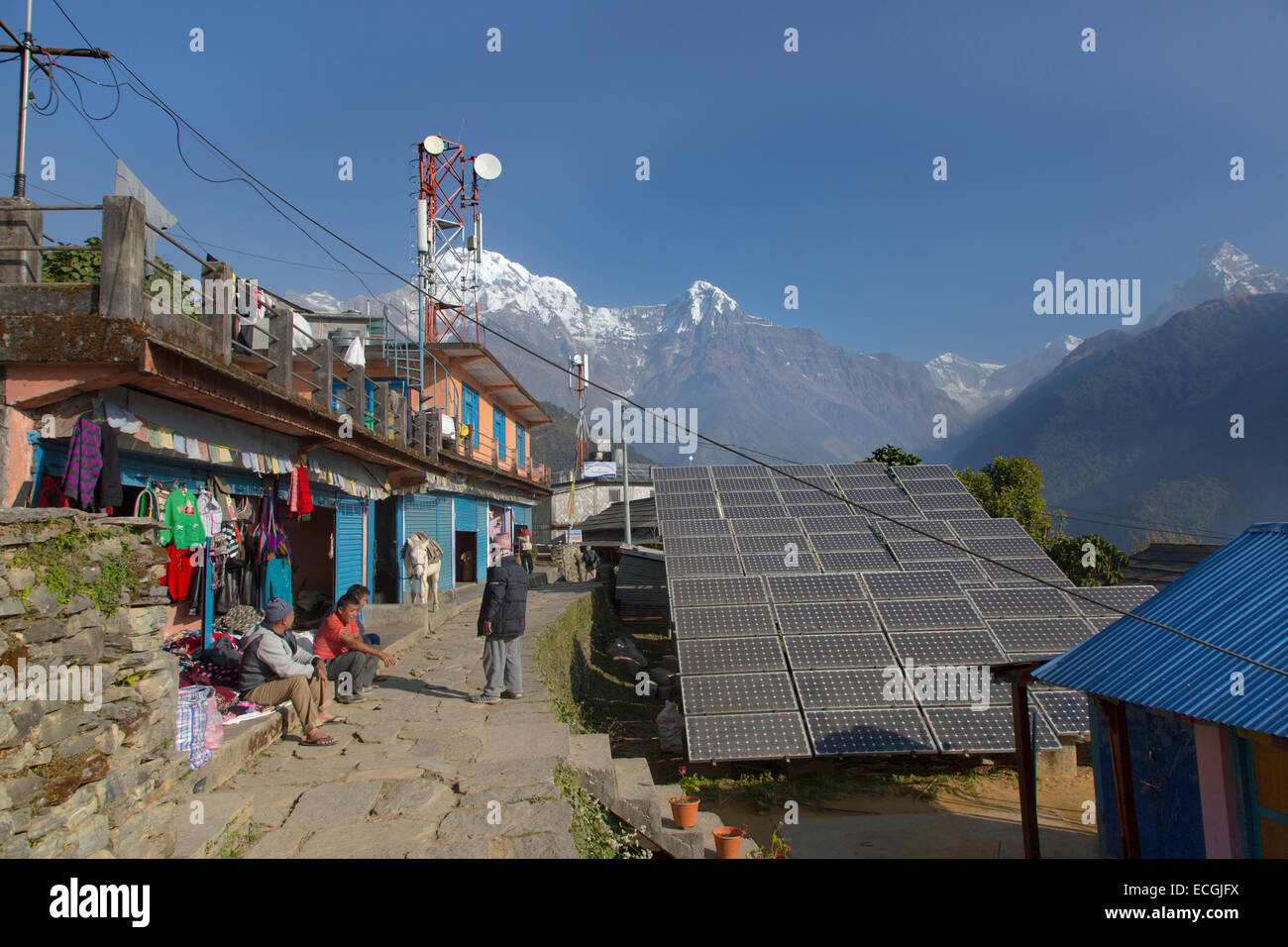 The Mountain village of Ghandruk and new solar panels for green energy around 2000 metres with Annapurna in background Stock Photo