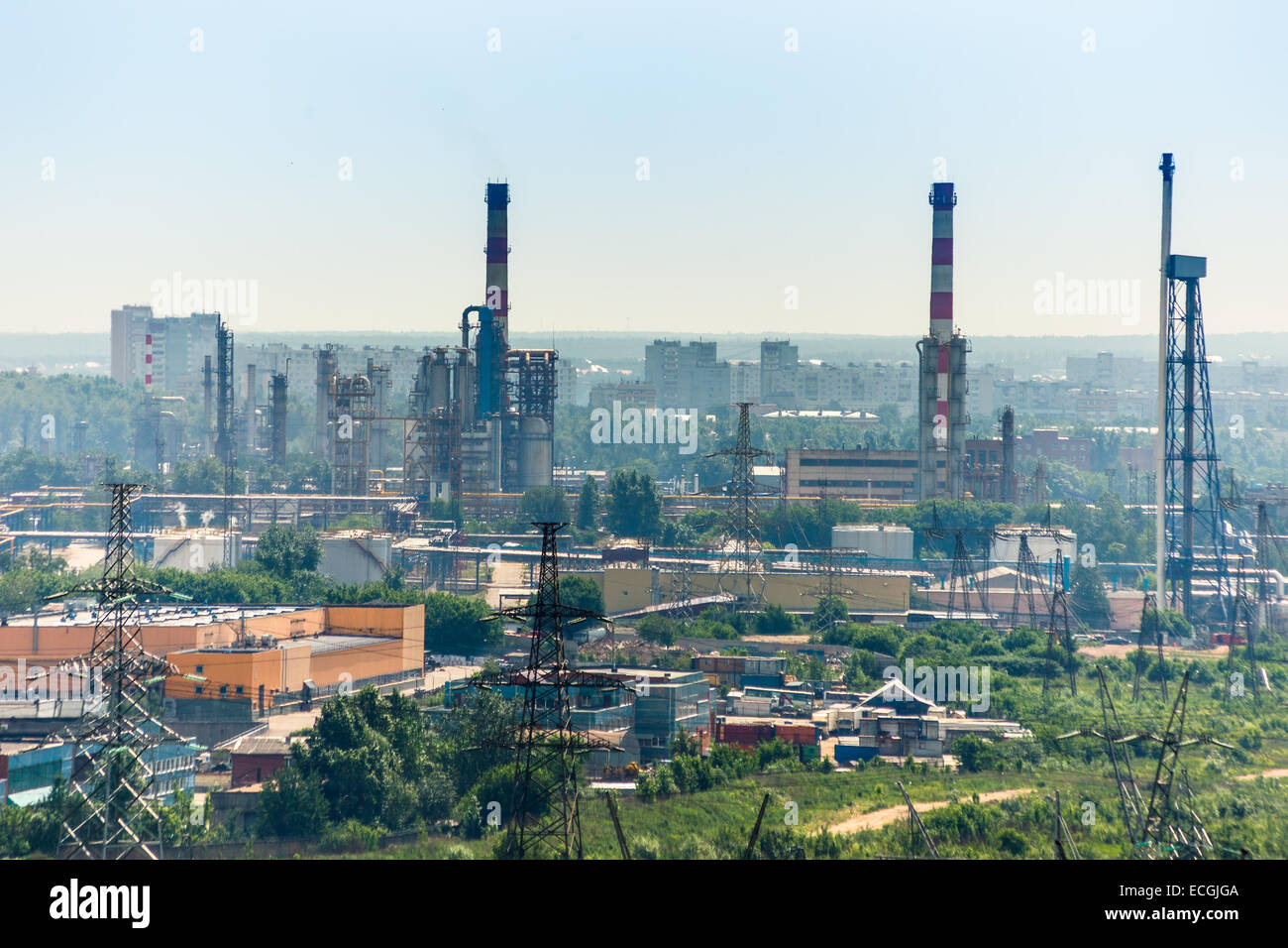 Extreme industry area with refinery, electric lines and residential buildings Stock Photo
