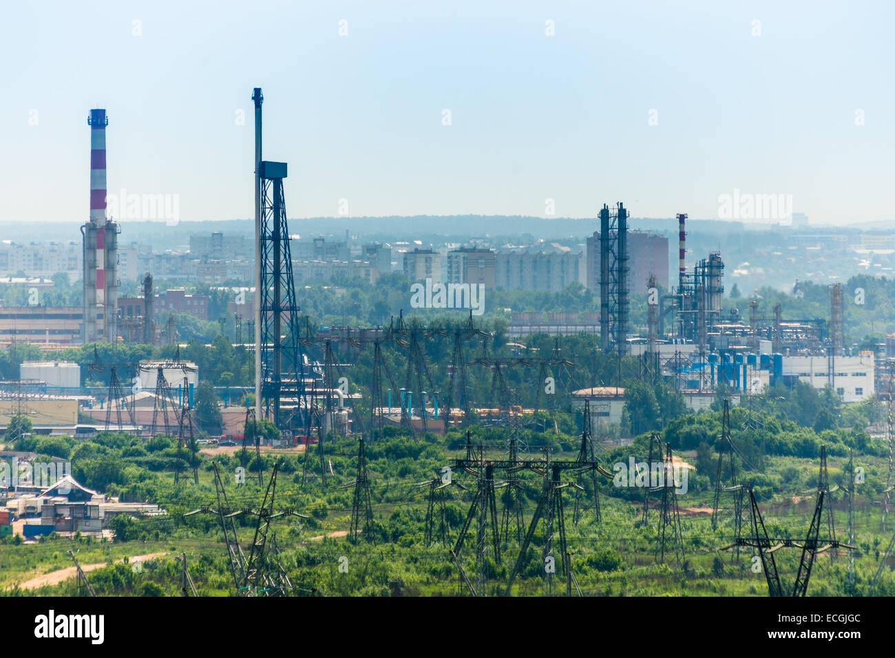 Extreme industry area with refinery, electric lines and residential buildings Stock Photo