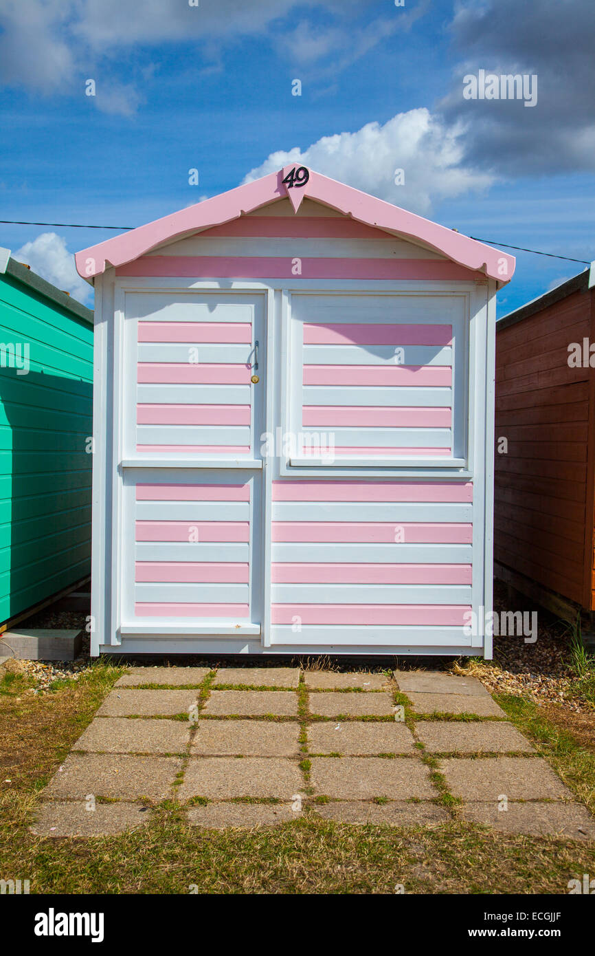 Pink and white stripped beach hut at Brightlingsea Stock Photo