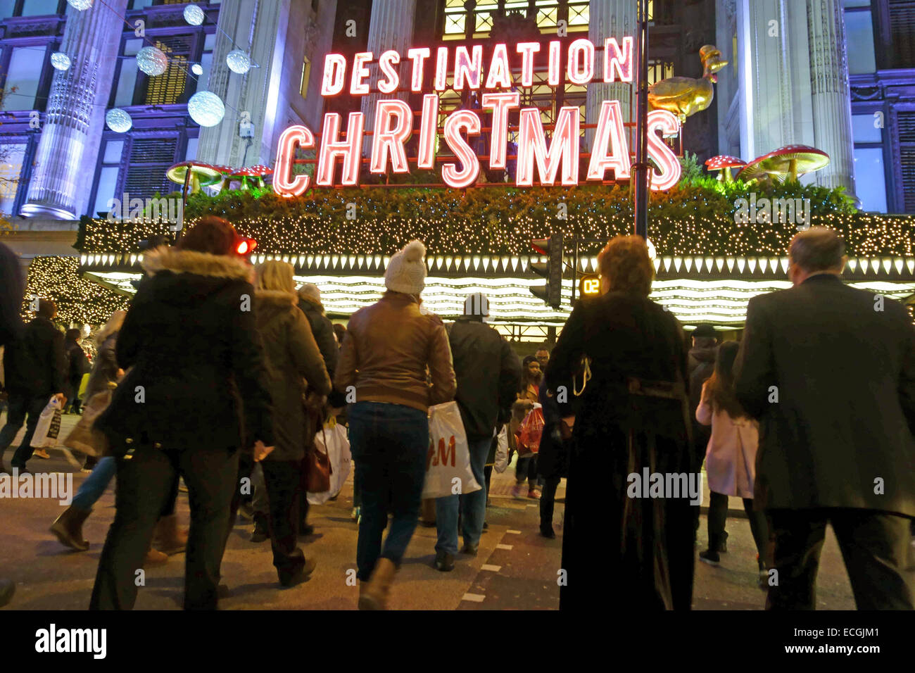 Christmas shoppers in Oxford Street, London cross road in front of Selfridges department store Stock Photo