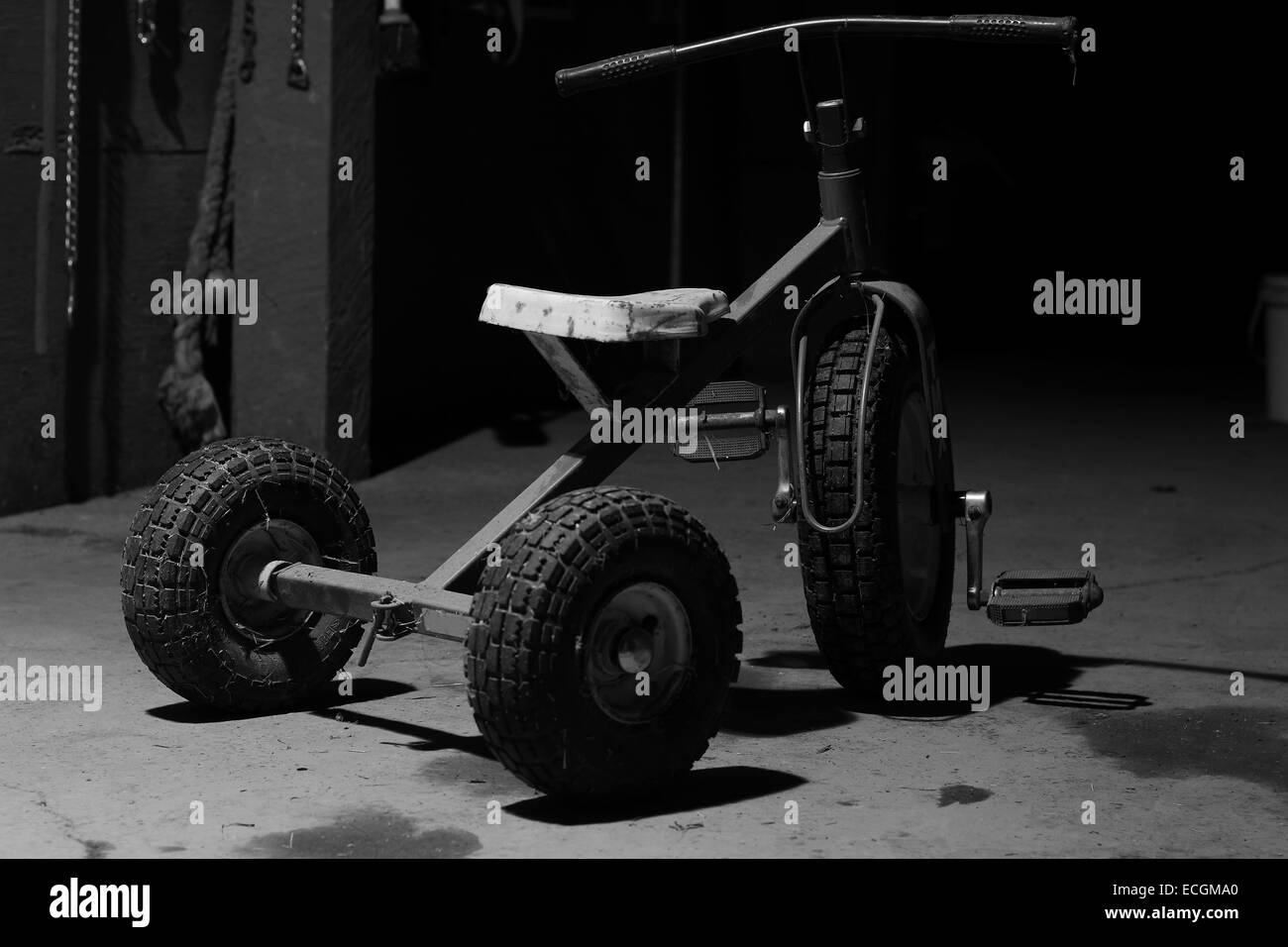 An antique tricycle in a barn still life Stock Photo