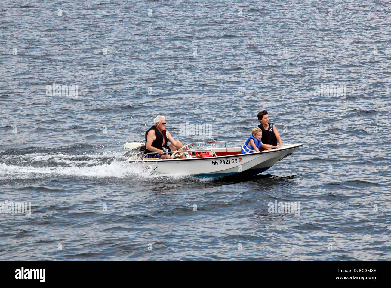 Boating sailing in a small Boston whaler on Lake Winnipesaukee New Hampshire USA America Stock Photo