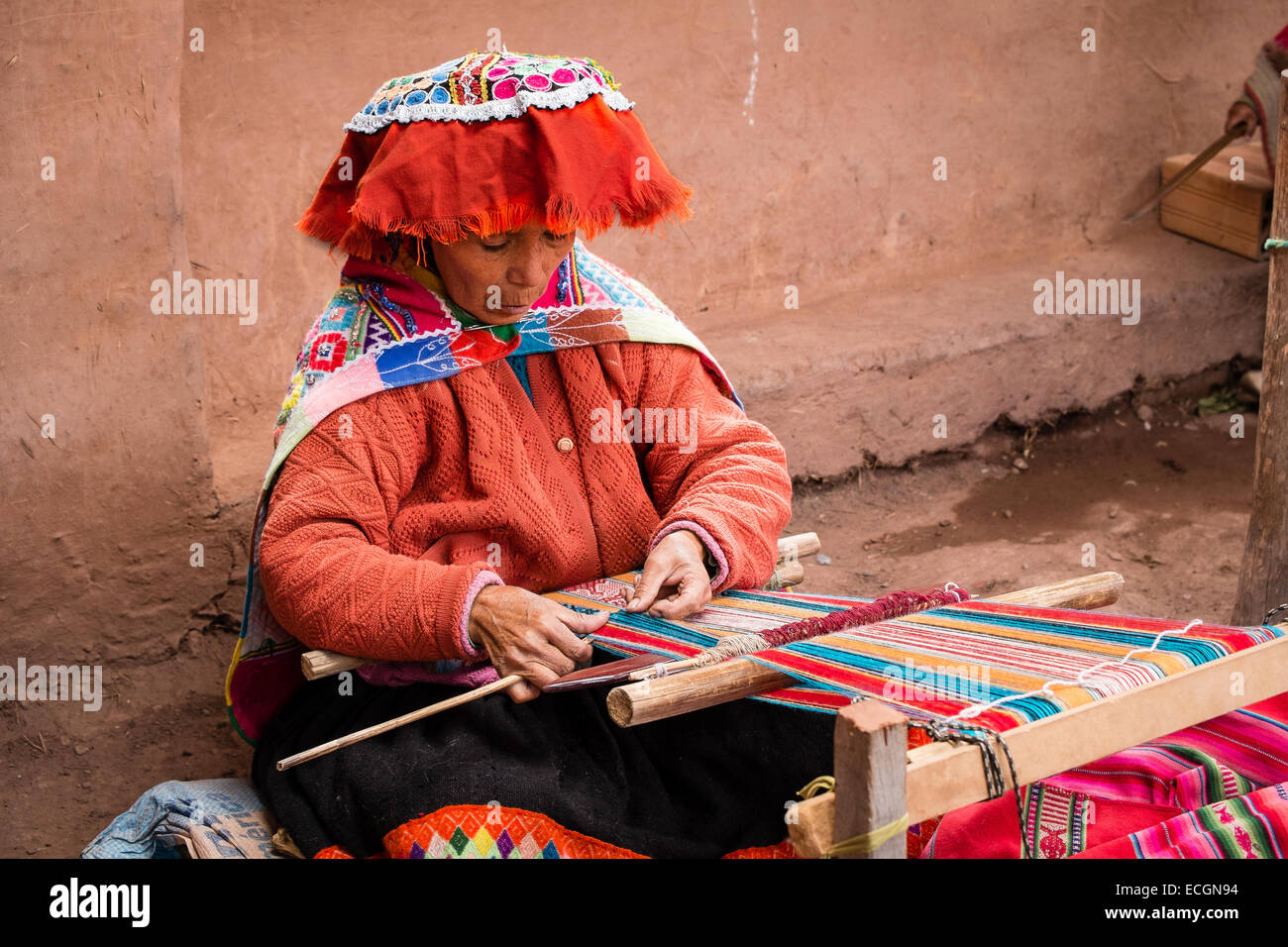 Peruvian woman weaving cloth from alpaca wool Stock Photo