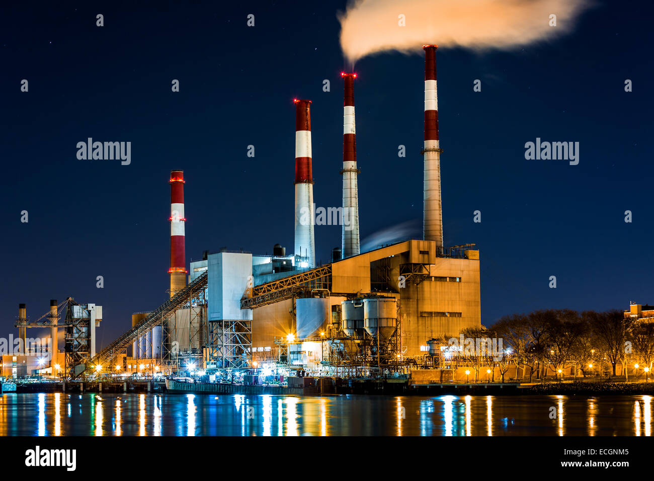 Power station with a steam cloud blown by the wind in a cold starry winter night` Stock Photo