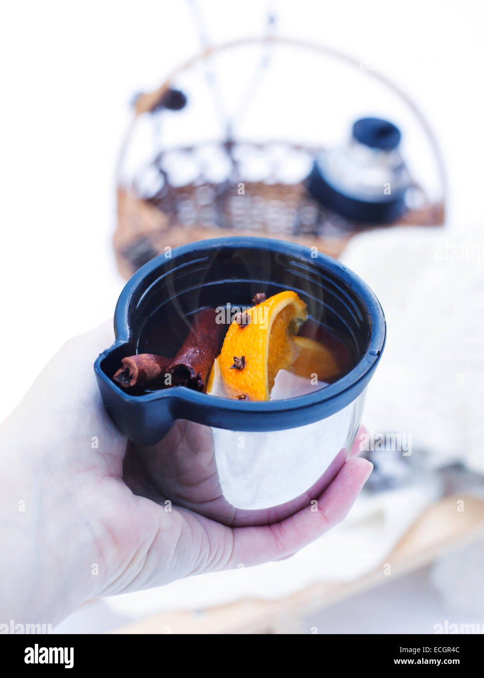 Hand holding a cup of mulled wine. Selective focus Stock Photo