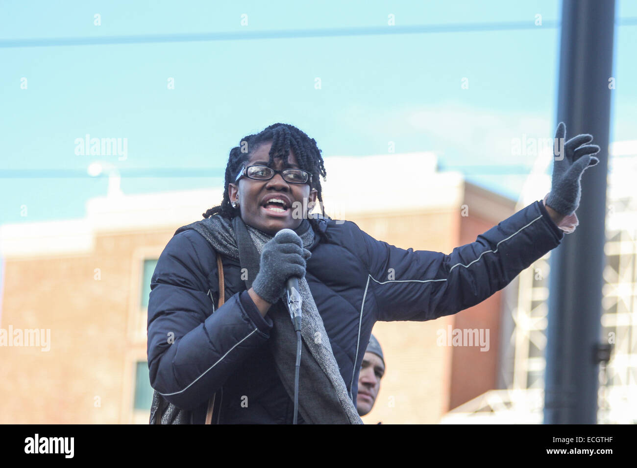 Boston, Massachusetts, USA. 13th December, 2014. A woman speaks during the Millions March rally in Boston, Massachusetts, USA. The protest, like those in other cities throughout the United States on this day, is in response to recent grand jury verdicts not indicting the police officers who  killed unarmed black men Michael Brown and Eric Garner, and to the longstanding problems of racism and police brutality. Credit:  Susan Pease/Alamy Live News Stock Photo