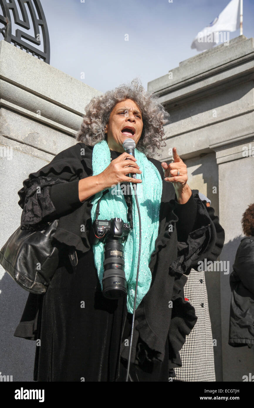Boston, Massachusetts, USA. 13th December, 2014. A woman speaks at the Millions March rally in Boston, Massachusetts, USA.  The protest, like those in other cities throughout the United States on this day, is in response to recent grand jury verdicts not indicting the police officers who  killed unarmed black men Michael Brown and Eric Garner, and to the longstanding problems of racism and police brutality. Credit:  Susan Pease/Alamy Live News Stock Photo