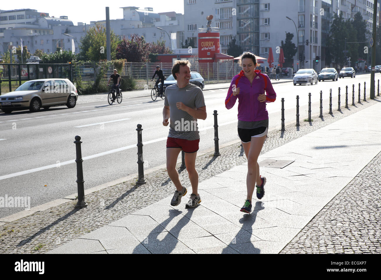 male female runner city street berlin Stock Photo