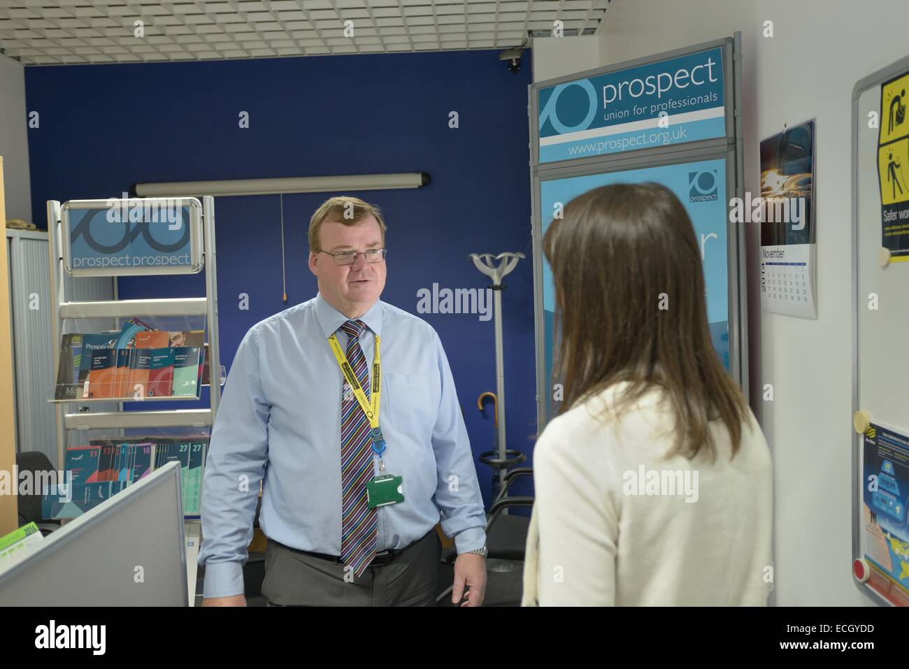 UK Met Office - Gordon Hutchinson full time Trade Union rep for Prospect in his office at the Met Office talking to a staff memb Stock Photo