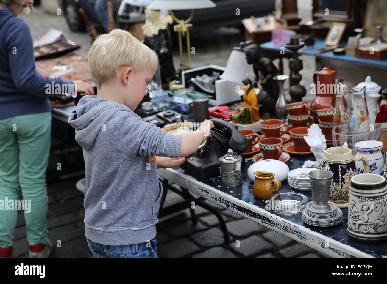 young boy flea market antique telephone berlin germany europe Stock Photo