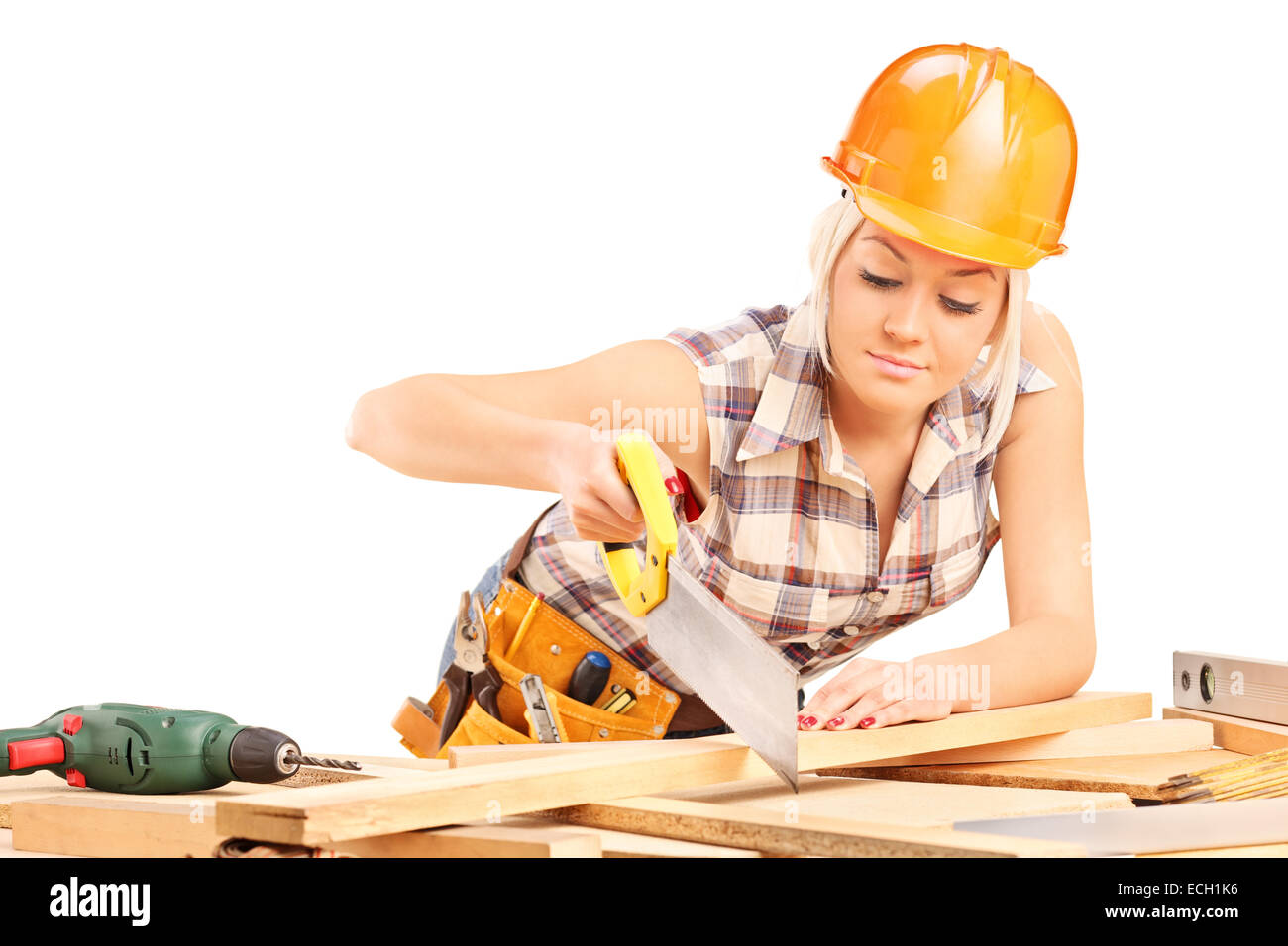 Female carpenter cutting plank with a handsaw isolated on white background Stock Photo