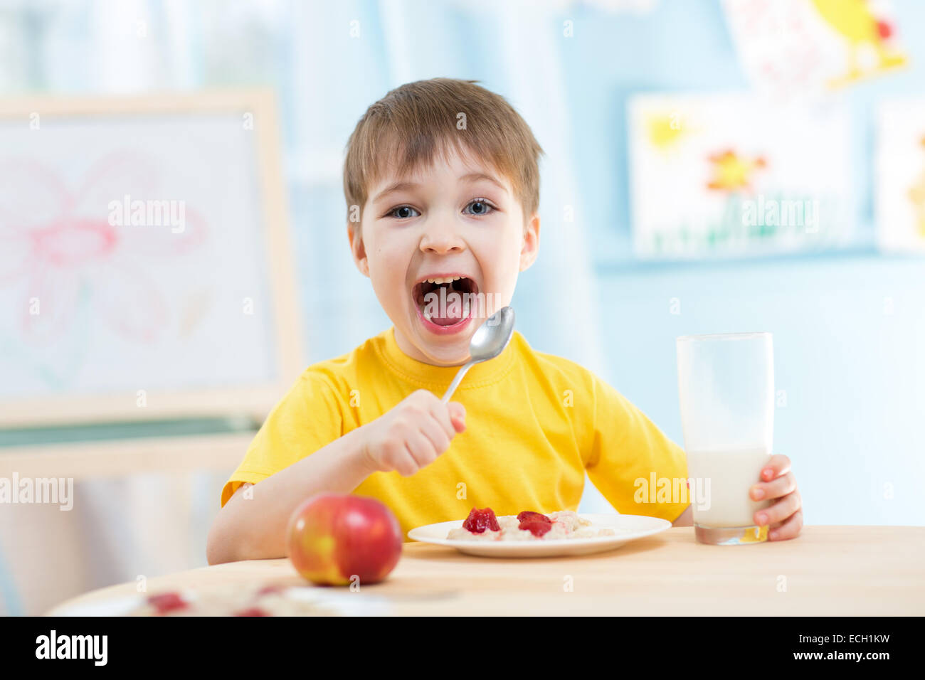 kid eating healthy food at home Stock Photo