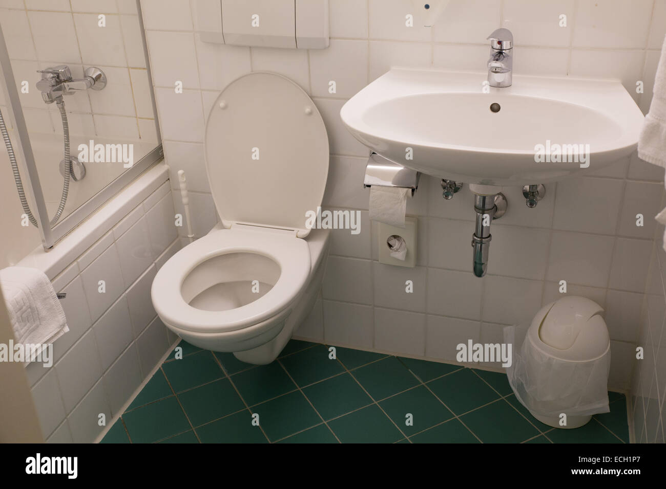 washroom bathroom toilet sink white tile hotel Stock Photo