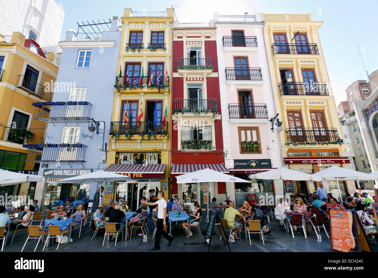 Street cafes and restaurants next to colorful buildings, Valencia, Spain Stock Photo