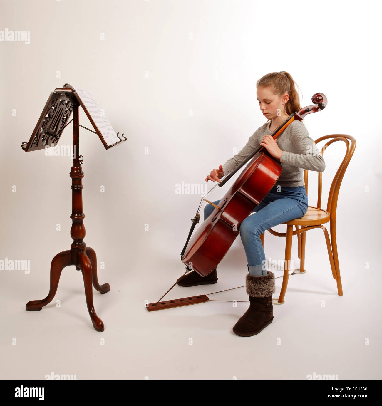 young girl playing the cello, pizzicato, plucking, plucked. Stock Photo
