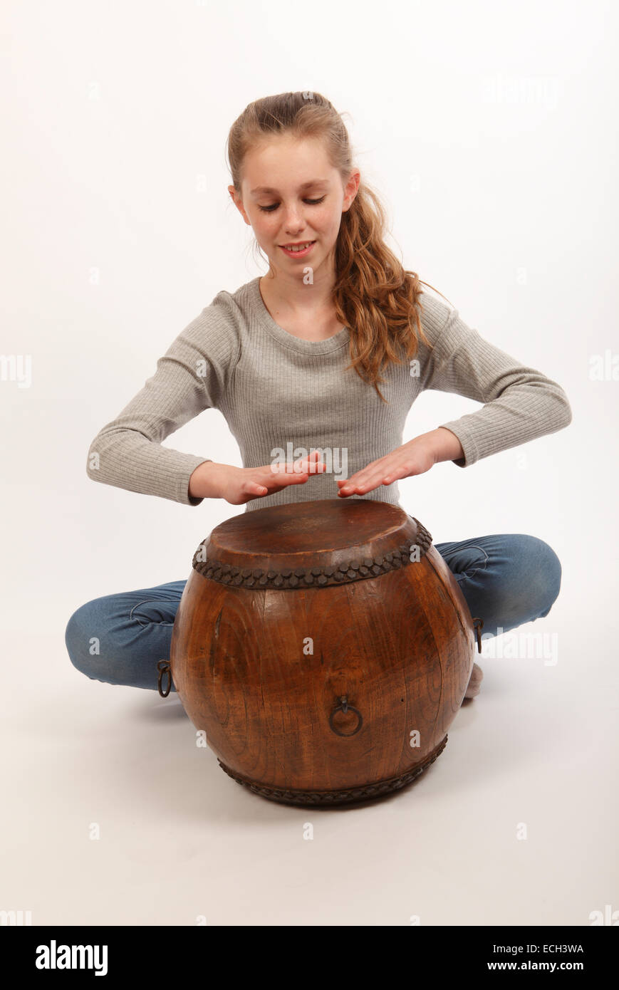 young girl playing a hand drum, a chinese double headed tom tom Stock Photo