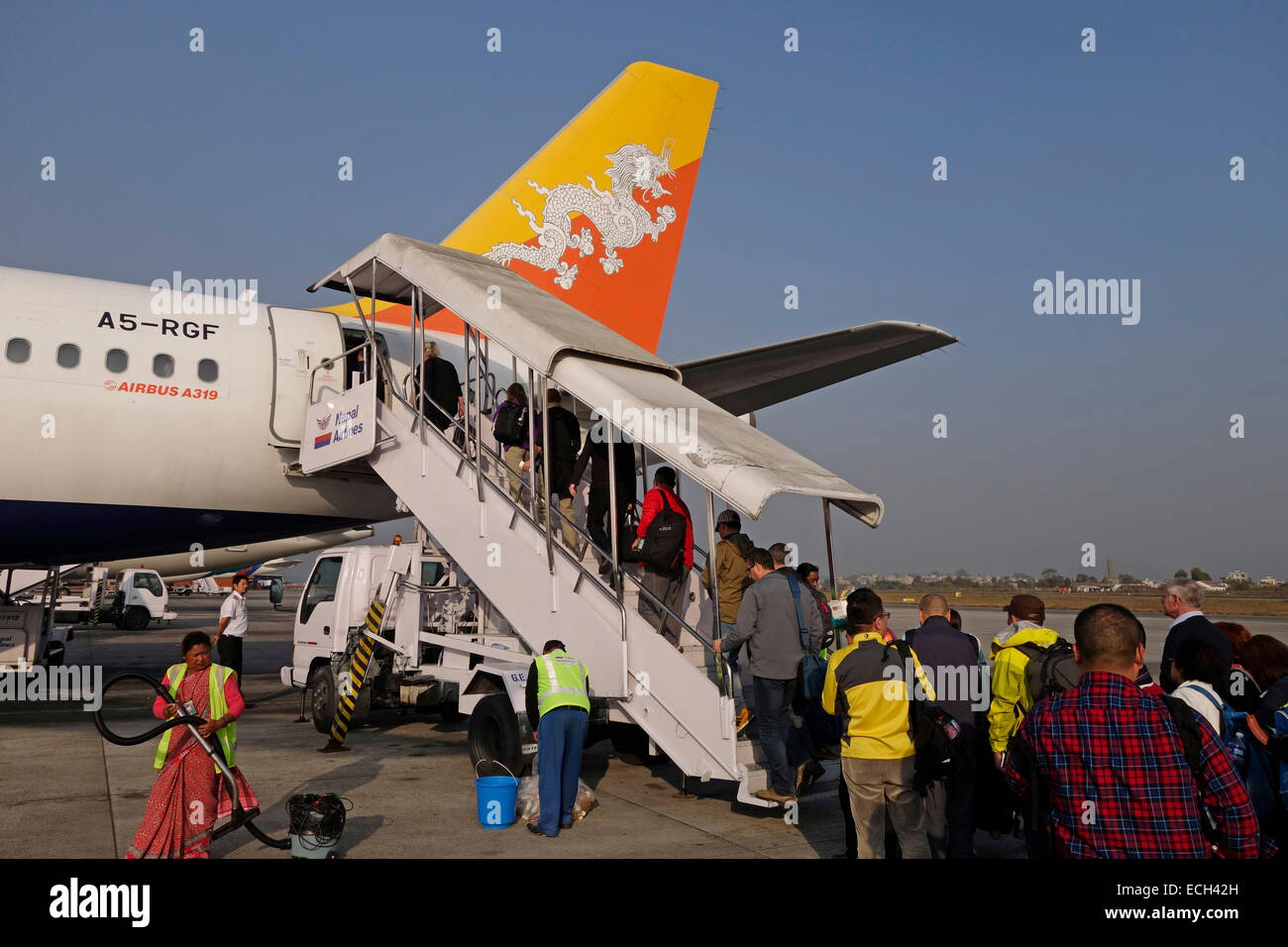 Passengers board an Airbus A319-100 airplane of Druk National carrier of Bhutan at Tribhuvan International airport in Kathmandu Nepal Stock Photo