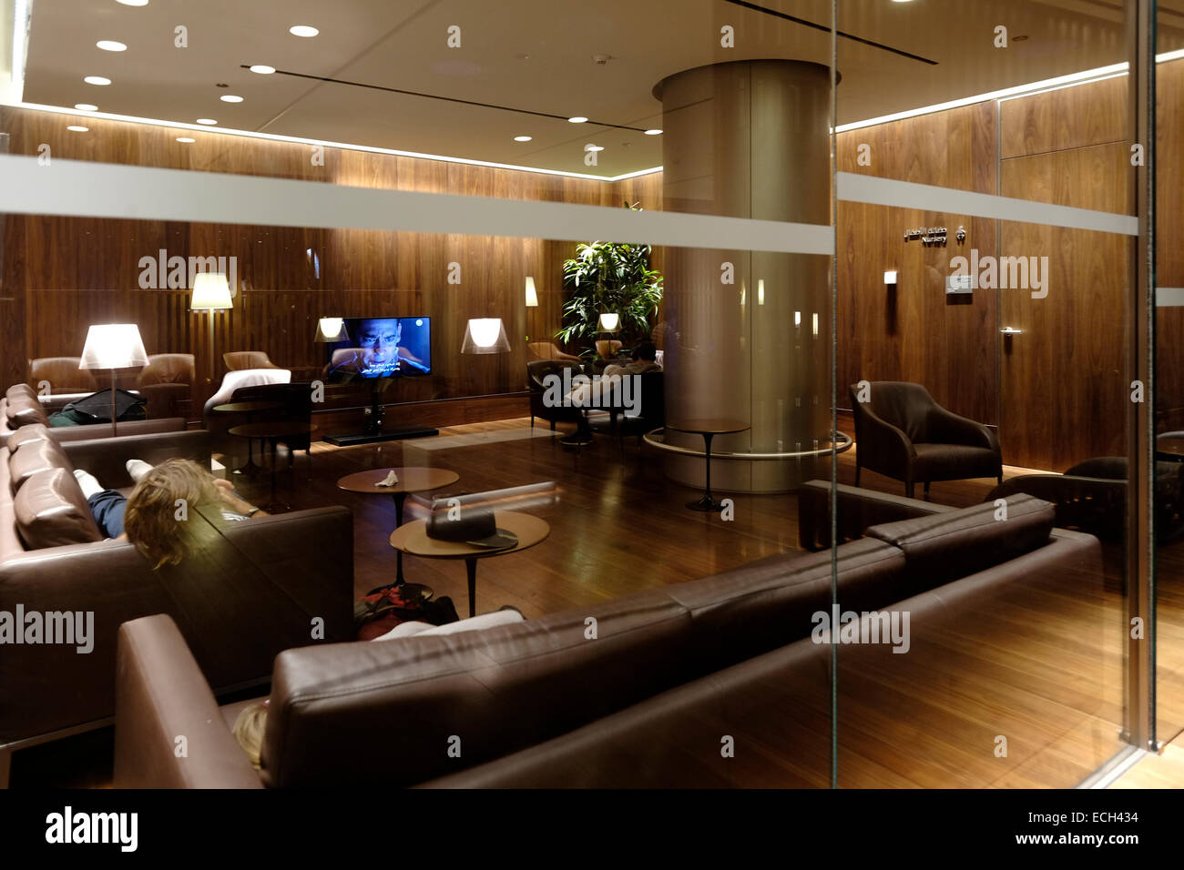 Passengers sleep on sofas inside the Family room of Oryx lounge at