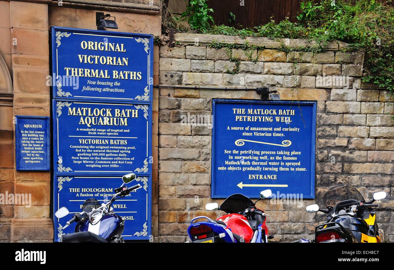 Signs for Victorian Thermal Baths, Bath Aquarium and the Petrifying well in the town centre, Matlock Bath, Derbyshire, England. Stock Photo