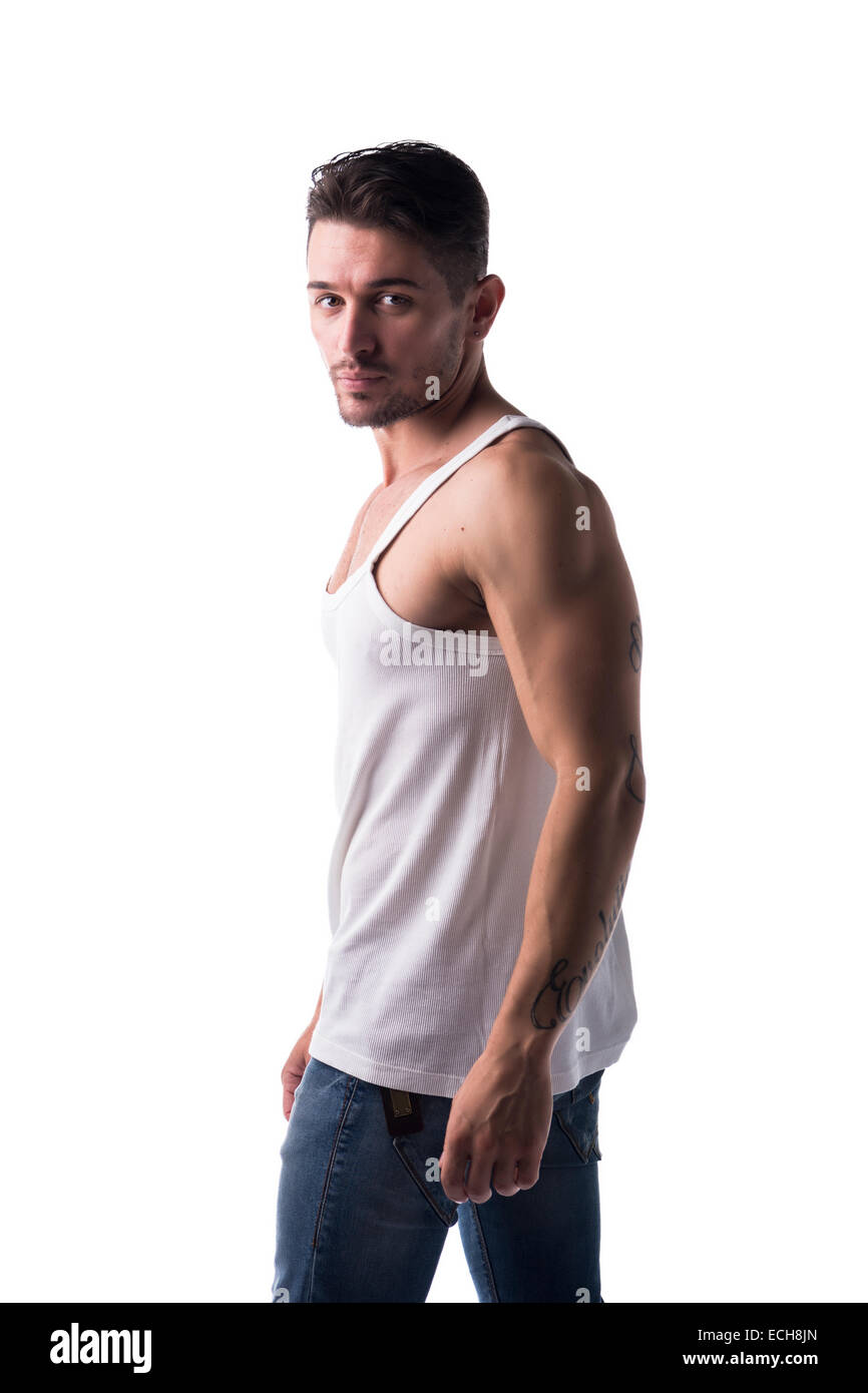 Handsome athletic man with tank top and jeans looking at camera, isolated on white Stock Photo