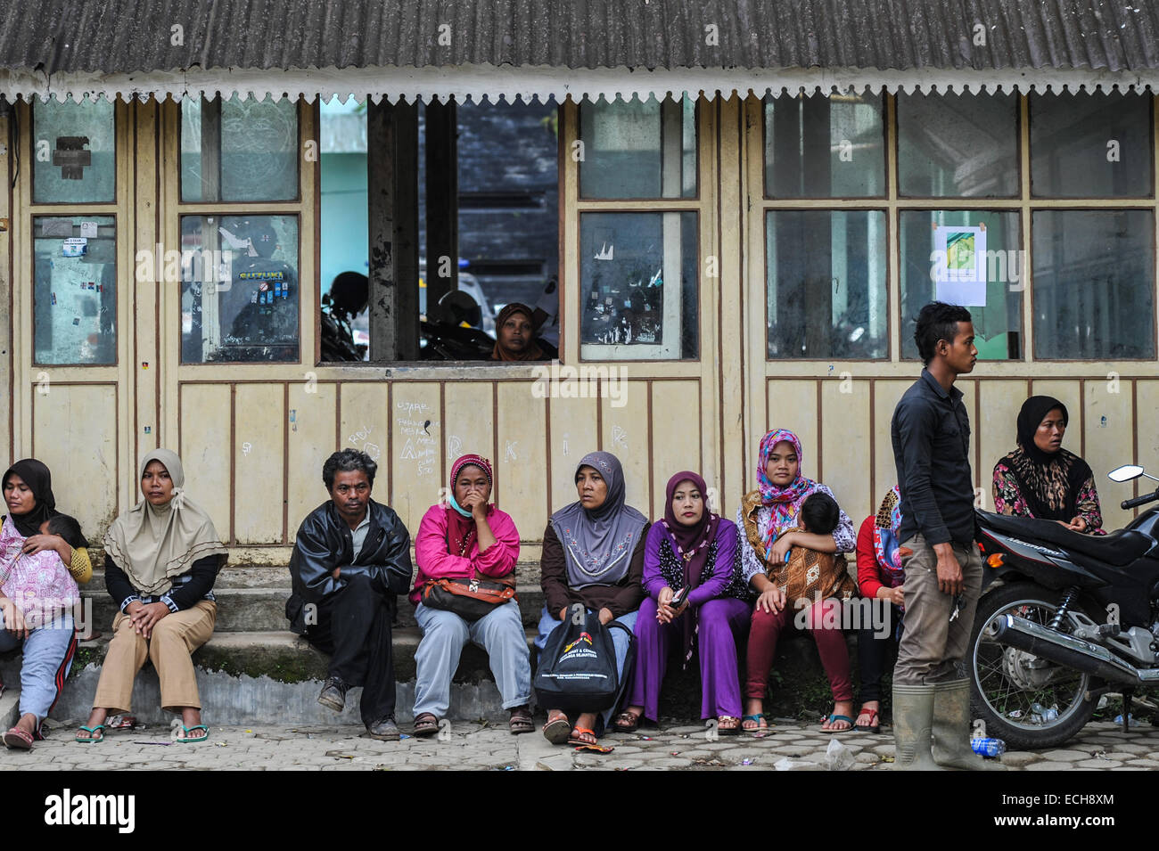 Banjarnegara. 15th Dec, 2014. Relatives of victims of landslide wait for new information at the Karangkobar health centre in Indonesia, Dec. 15, 2014. A landslide hitting the village of Sampang in Banjarnegara of Indonesia on Friday has buried hundreds of people including local residents and visitors. Rescuers have found 47 bodies in the location up to Dec. 15. Credit:  Veri Sanovri/Xinhua/Alamy Live News Stock Photo