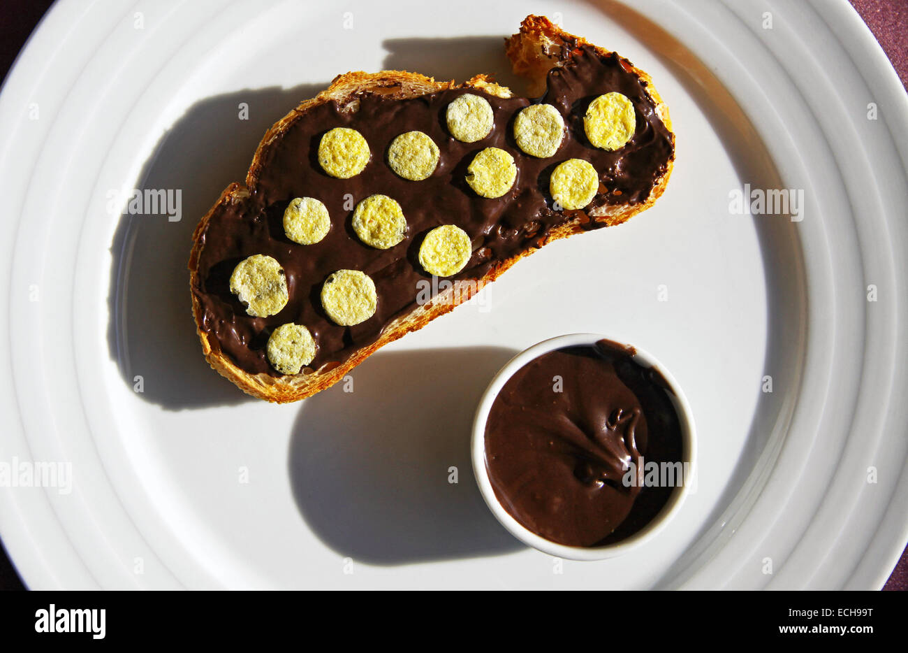 Slice of bread with chocolate cream on a plate Stock Photo