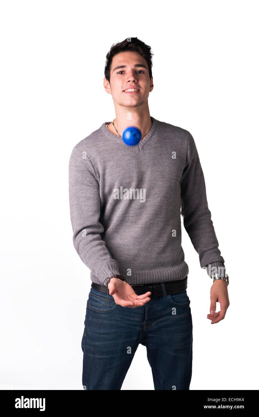 Happy young man playing with small rubber ball with smiley on it, isolated on white Stock Photo