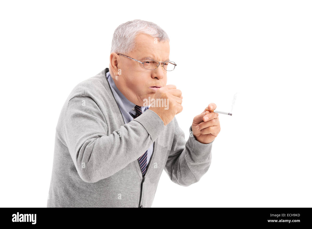 Senior smoking a cigar and coughing isolated on white background Stock Photo