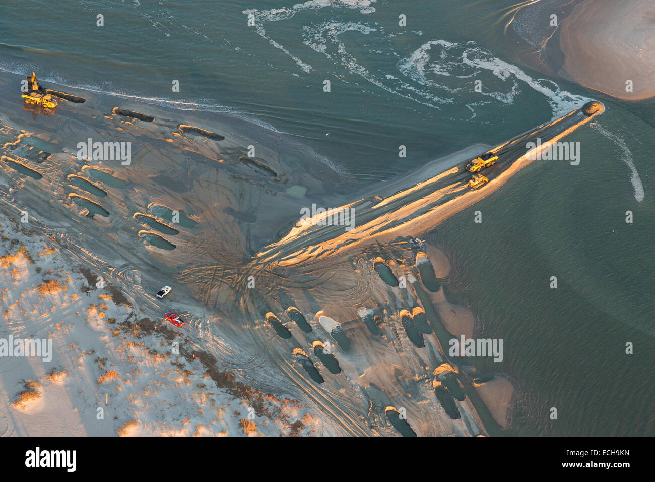 Aerial view of giant holes in the sand during a beach restoration