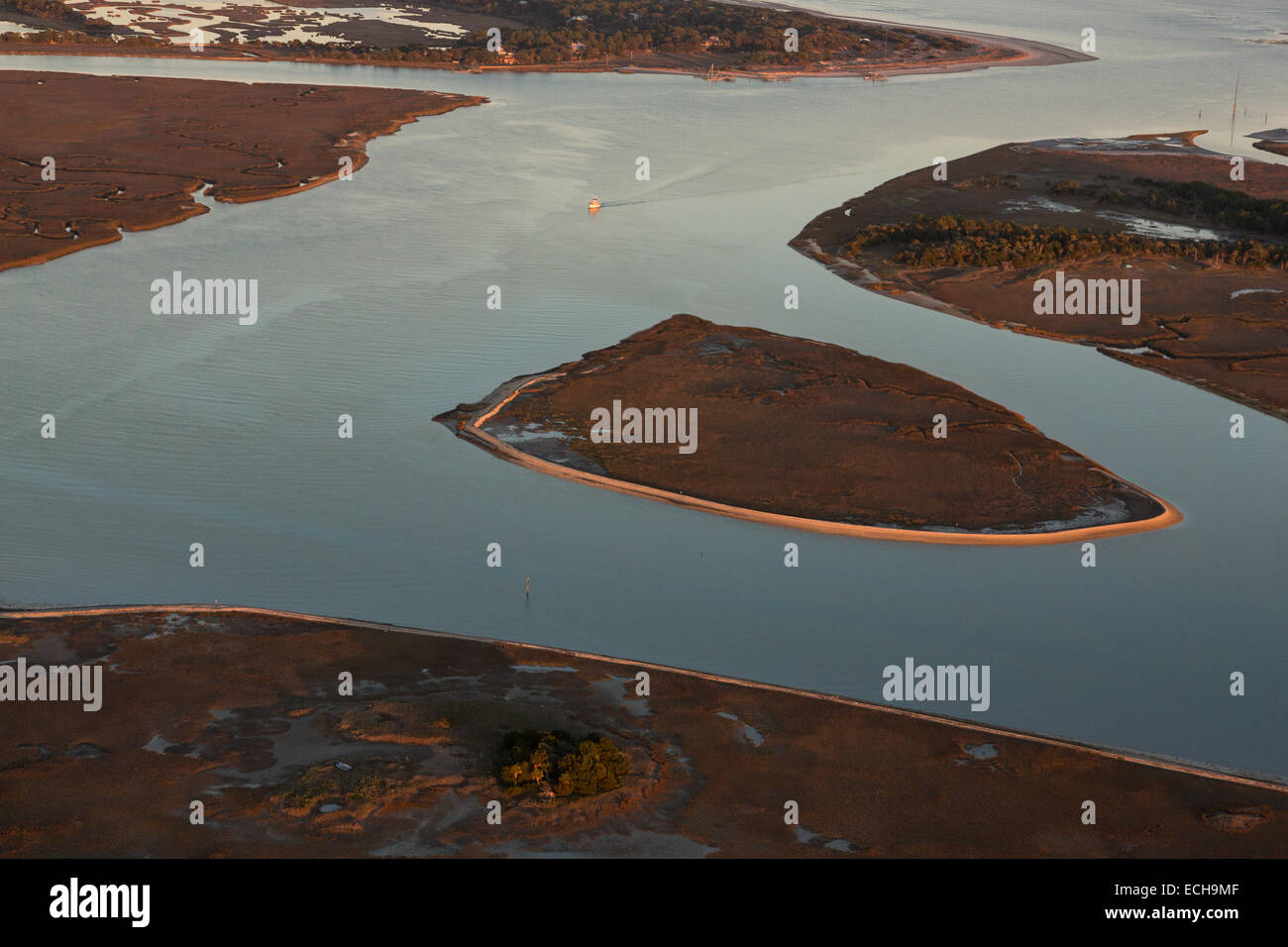 Aerial view of a boat entering the intracoastal waterway from an inlet ...