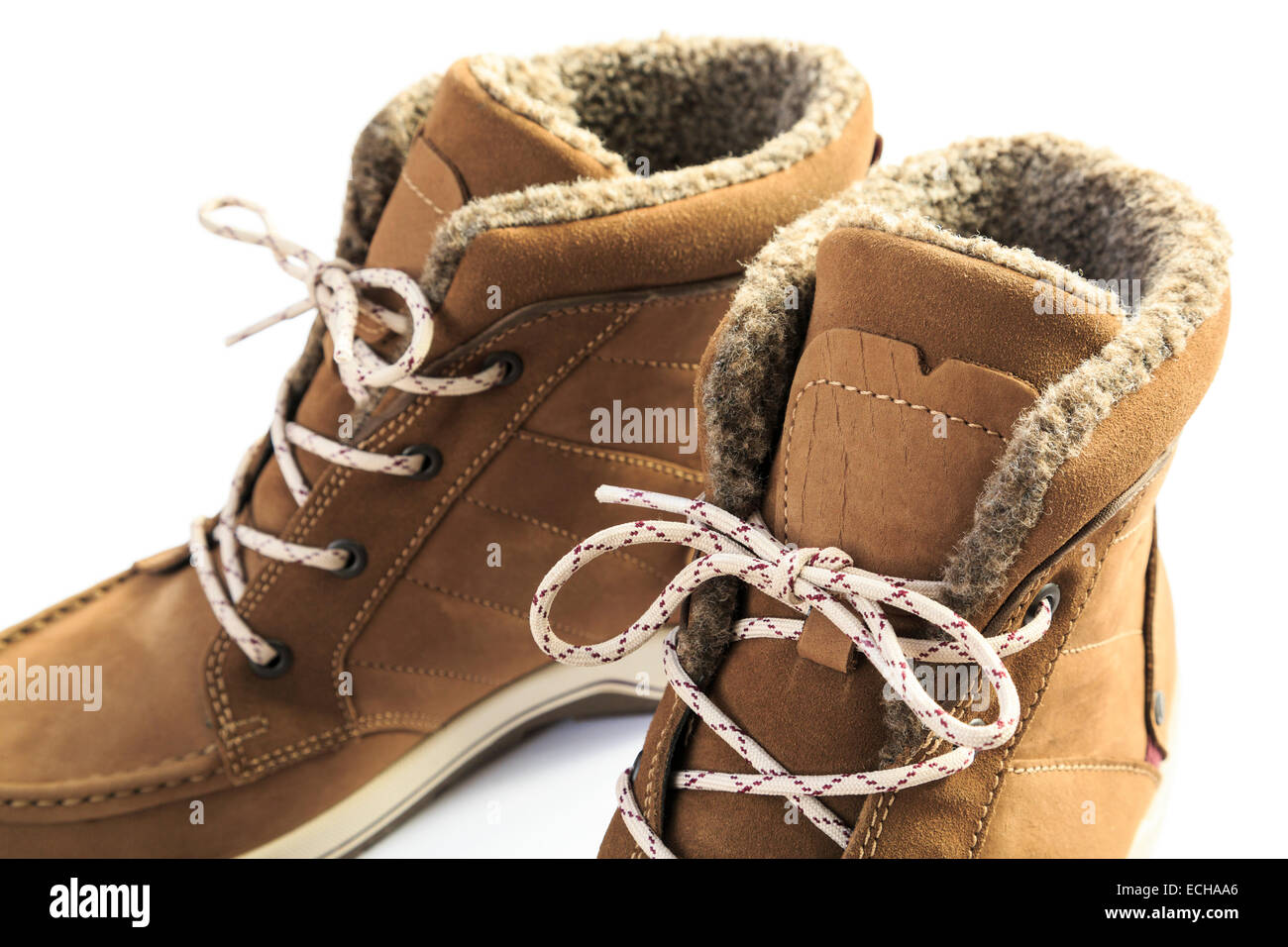 Close up of a pair of ladies women's leather warm fur-lined lace-up winter boots isolated on a white background. UK Stock Photo