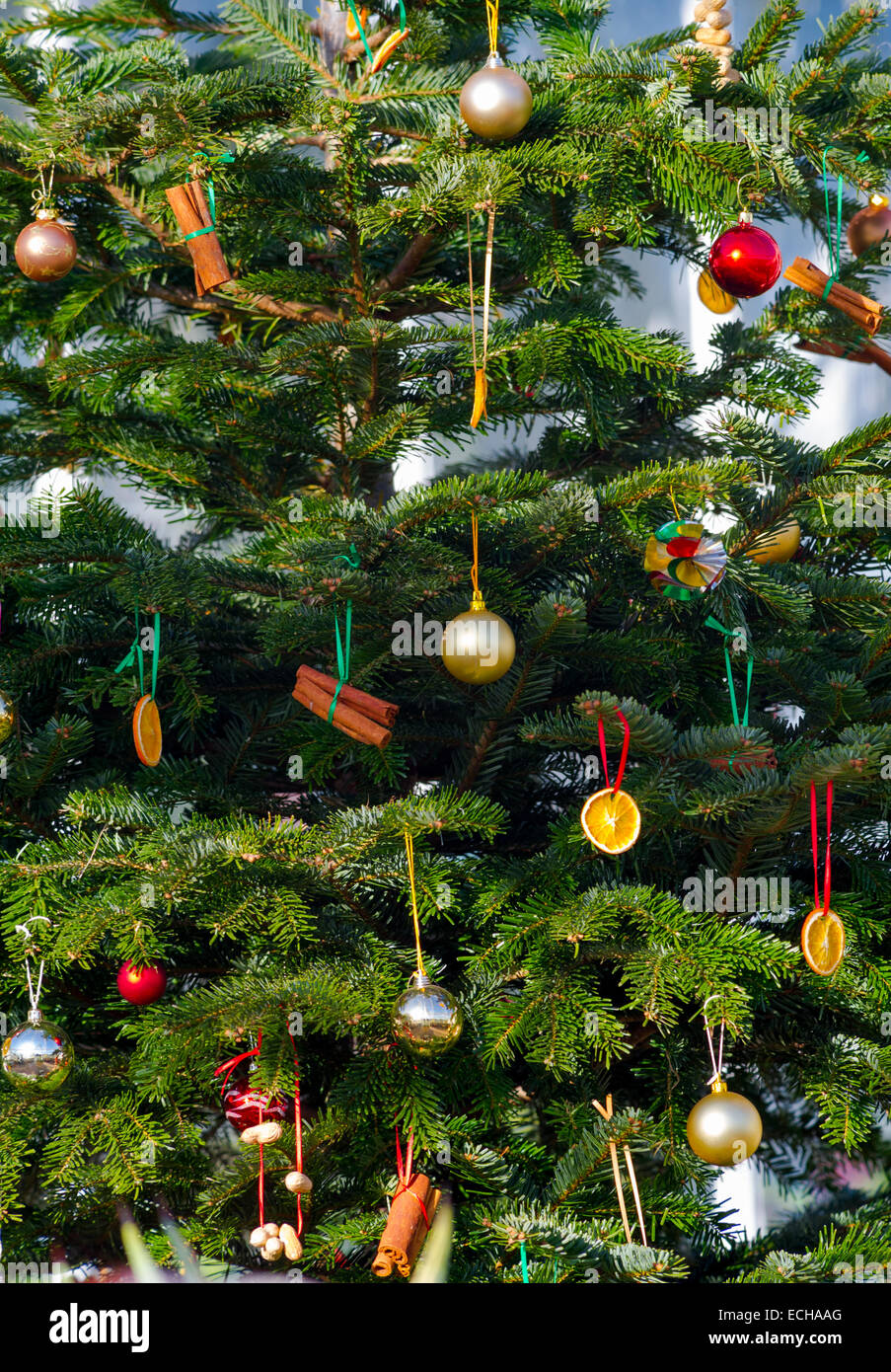 Christmas tree placed outside decorated with baubles and other decorations. Stock Photo