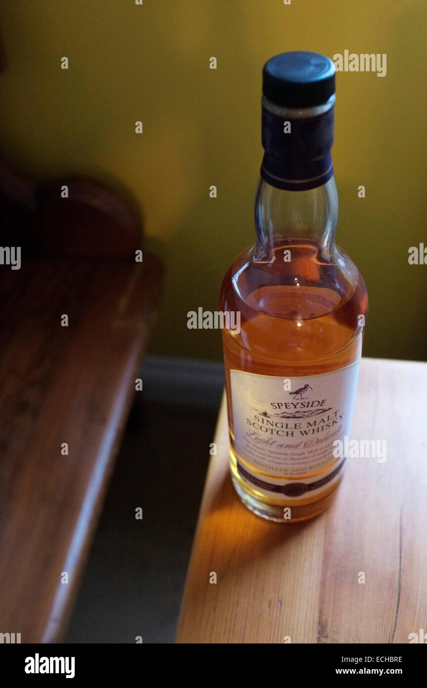 A bottle of Single Malt Scotch Whisky resting on a wooden table. Stock Photo