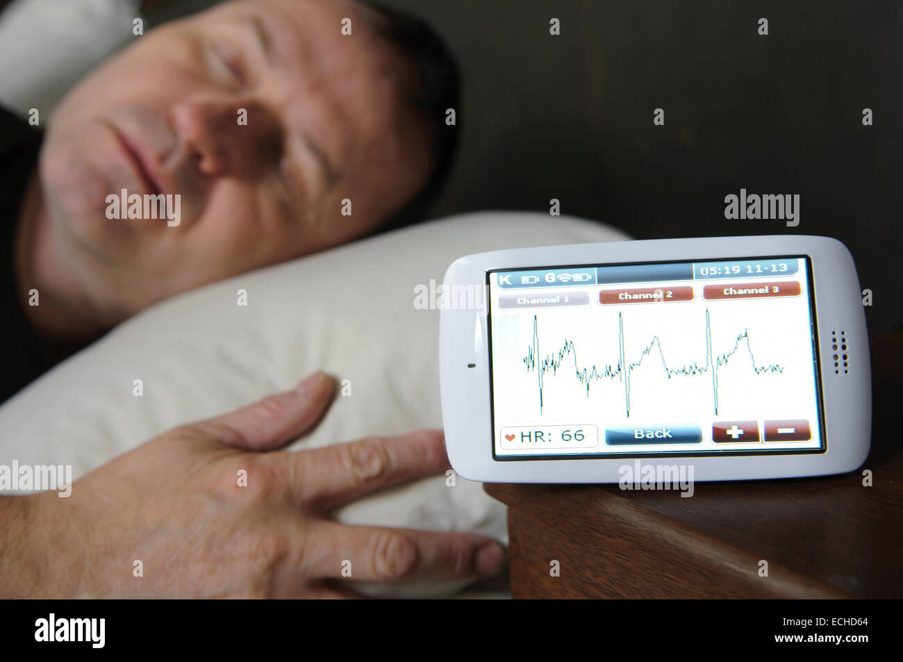 Man sleeping while having his ECG monitored using a Custo Kybe heart monitor. Stock Photo