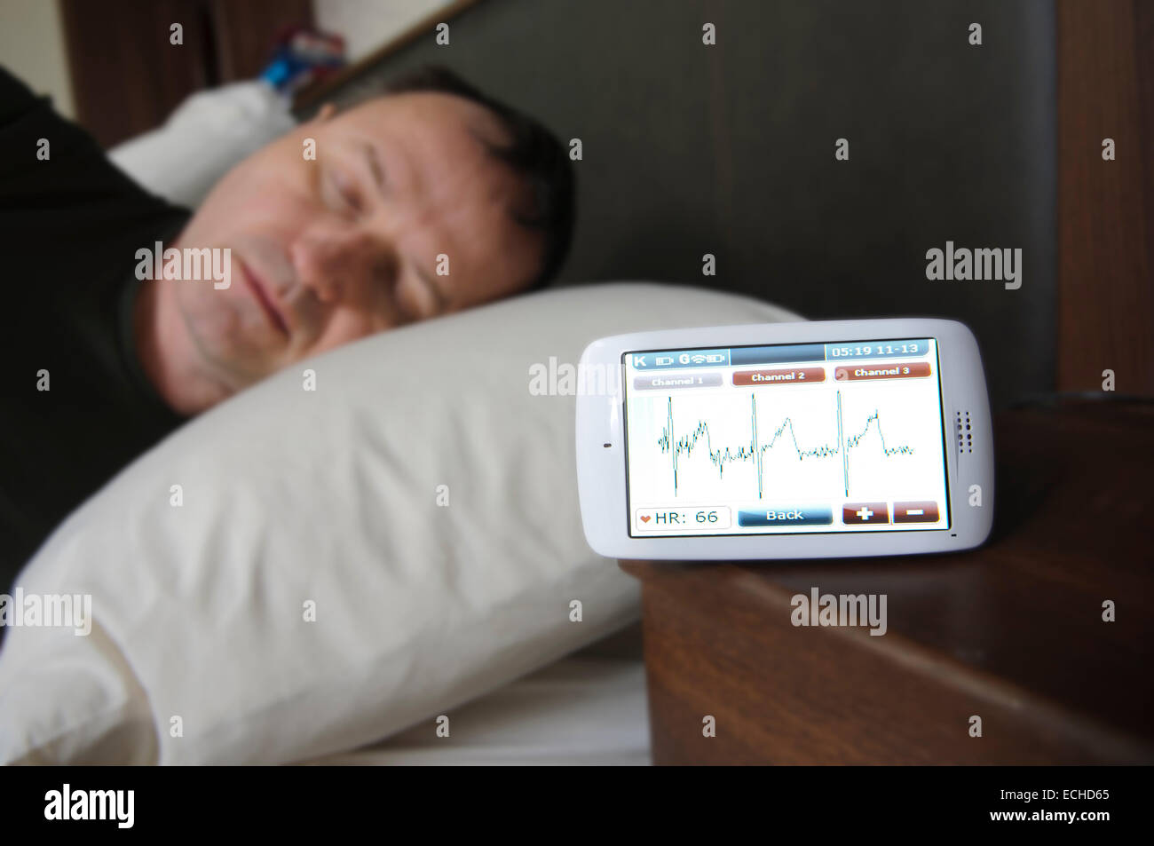 Man sleeping while having his ECG monitored using a Custo Kybe heart monitor. Stock Photo