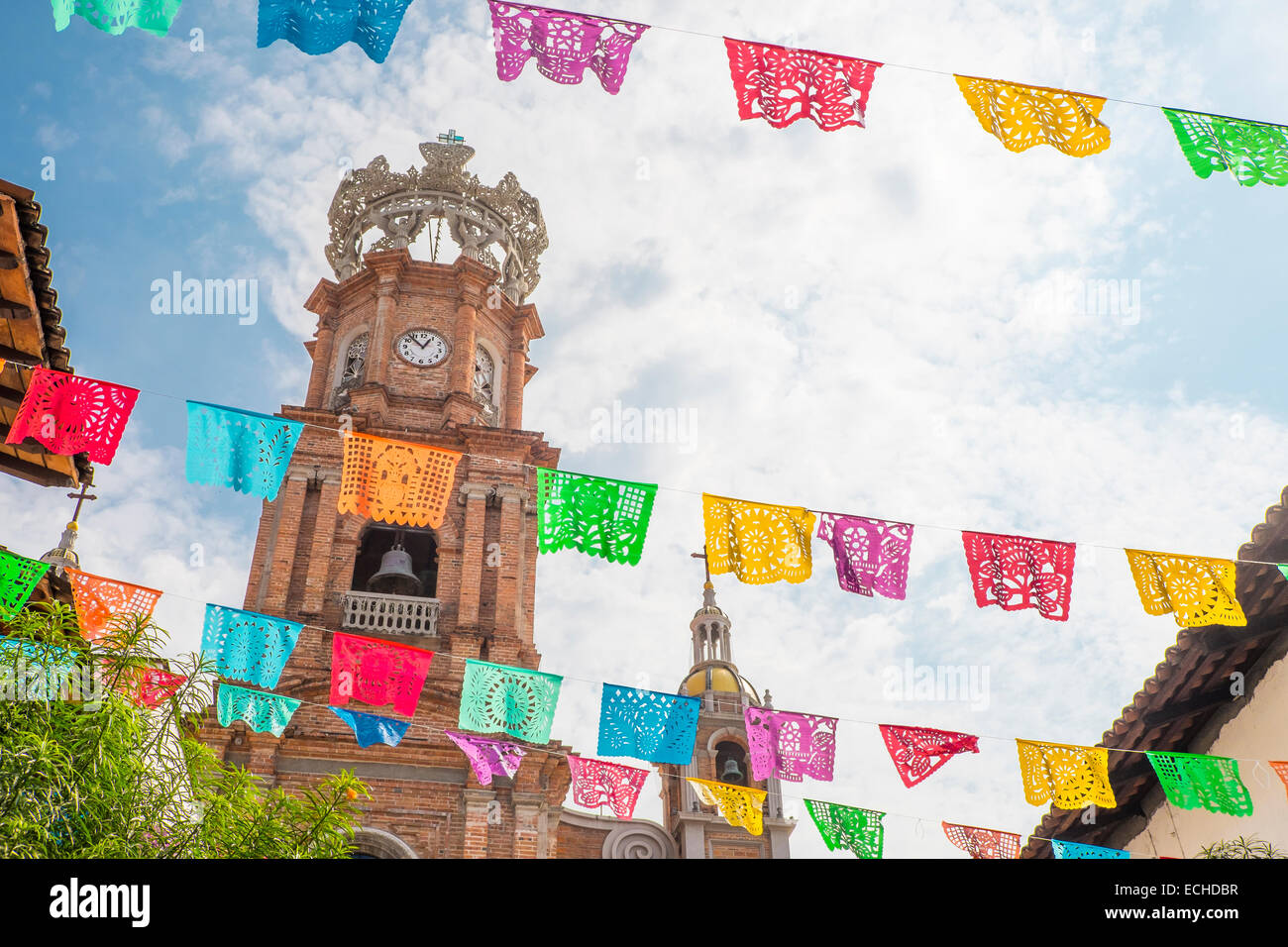 El Centro with Church of Our Lady of Guadalupe and colorful flag lines in front. Downtown Puerto Vallarta, Jalisco, Mexico. Stock Photo