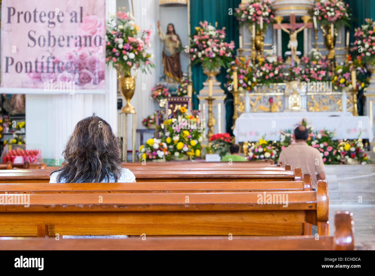 Mexican people praying in a church in Puerto Vallarta, Jalisco, Mexico Stock Photo